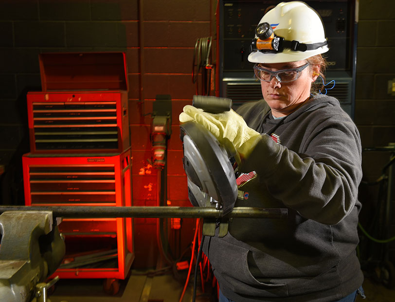 Woman holding machinery