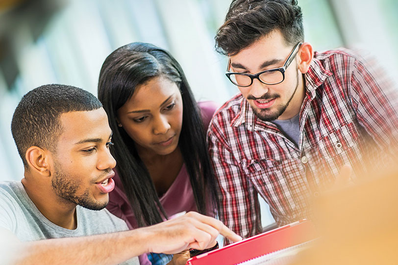 Three students looking at work