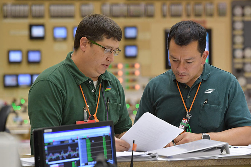Two men looking at files